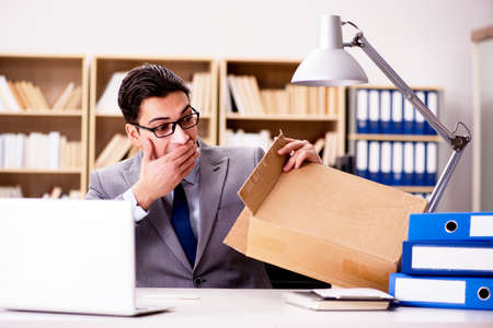 Businessman receiving parcel in officeの写真素材