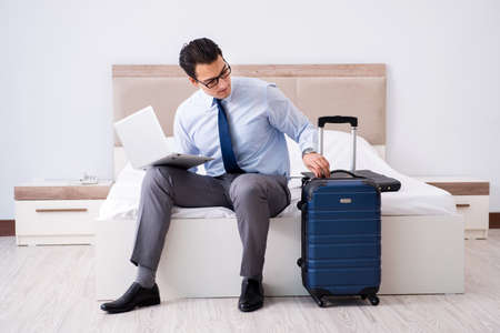 Businessman working in hotel roomの写真素材