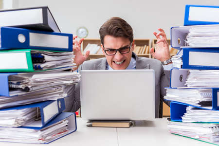 Busy businessman under stress due to excessive work