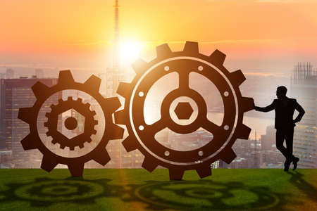 Businessman in teamwork concept with cogwheelsの写真素材