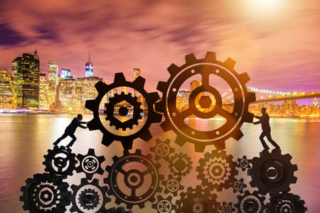 Businessman in teamwork concept with cogwheelsの写真素材