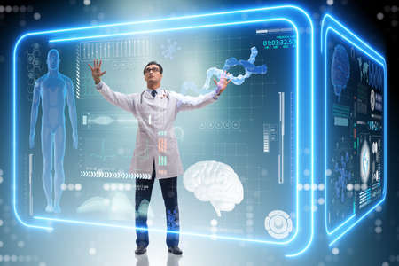 Doctor in futuristic medical concept pressing buttonの写真素材