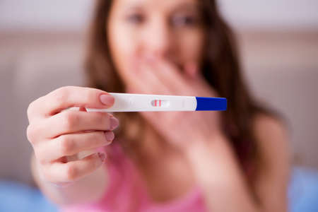 Woman discovering her positive pregnancy testの写真素材