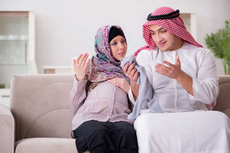 Young arab muslim family with pregnant wife expecting babyの写真素材