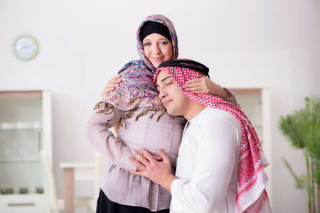 Young arab muslim family with pregnant wife expecting babyの写真素材