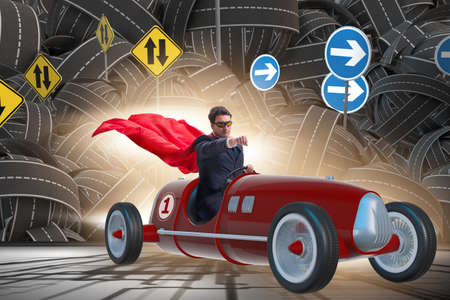 Superhero businessman driving vintage roadsterの写真素材