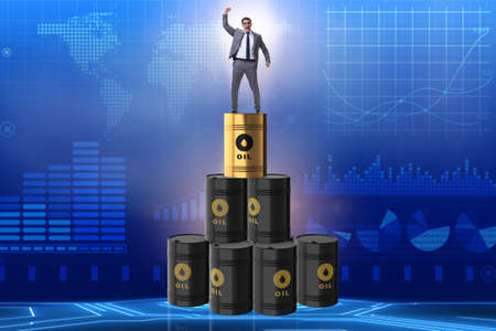 Businessman on top of oil barrelsの写真素材