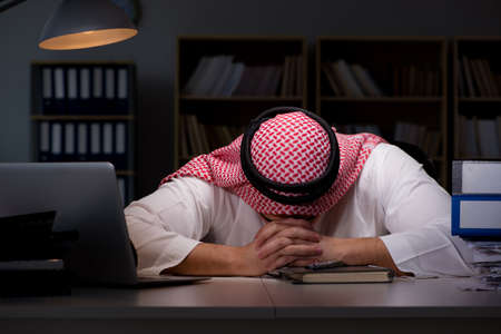 Arab businessman working late in officeの写真素材