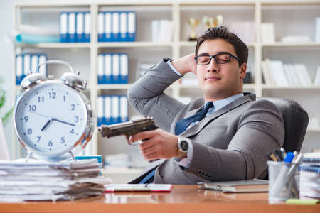 Young businessman in time management conceptの写真素材