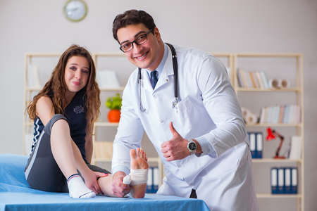 Traumatologist is taking care of the patientの写真素材