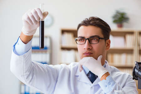 Chemical engineer working on oil samples in labの写真素材