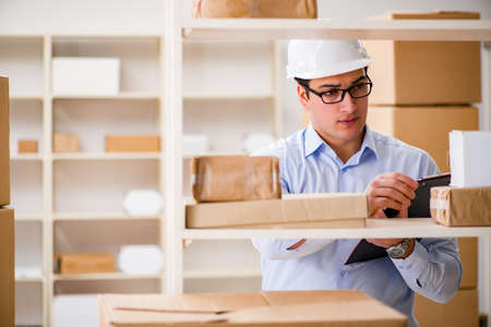 Man working in postal parcel delivery service officeの写真素材