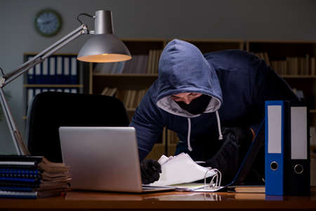 Hacker stealing personal data from home computerの写真素材