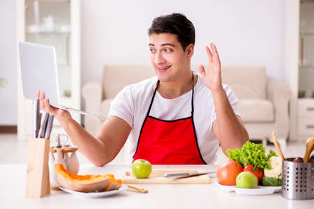 Funny man cook working in the kitchenの写真素材