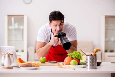 Food photographer taking photos in kitchenの写真素材