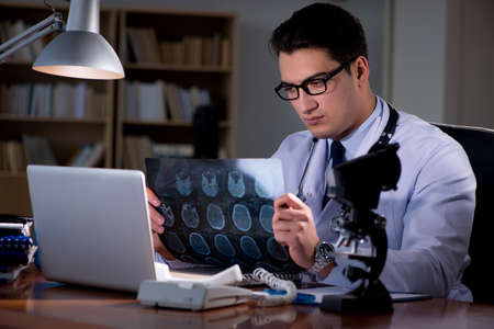 Young doctor working late in the officeの写真素材