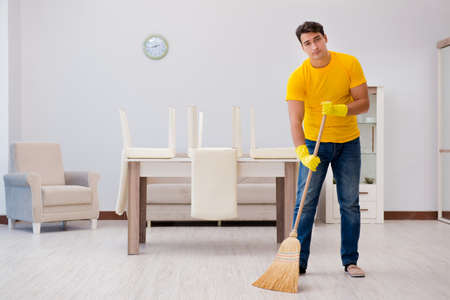 Man husband cleaning the house helping his wife