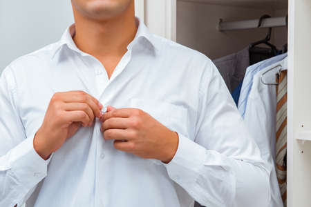 Businessman dressing up for work