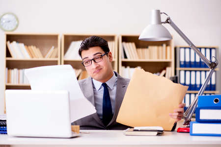 Businessman receiving letter envelope in officeの写真素材