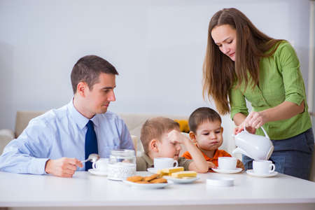 Happy family having breakfast together at homeの写真素材
