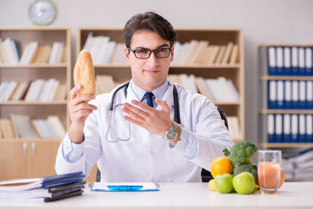 Doctor in dieting concept with fruits and vegetablesの写真素材