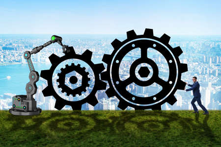 Teamwork concept with businessman and cogwheelsの写真素材