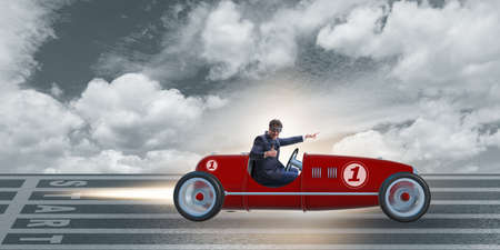 Businessman riding vintage roadster in motivation conceptの写真素材