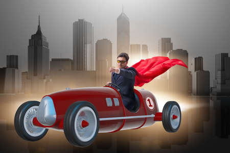 Superhero businessman driving vintage roadsterの写真素材