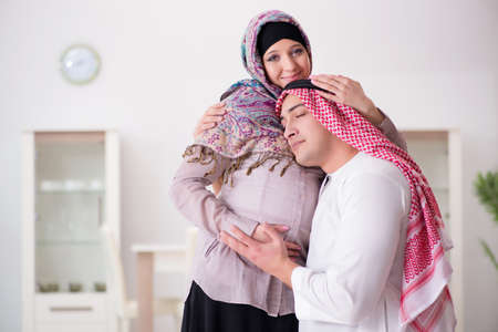 Young arab muslim family with pregnant wife expecting babyの写真素材