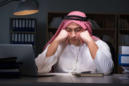 Arab businessman working late in officeの写真素材