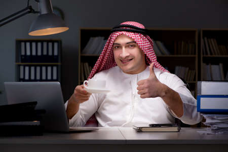 Arab businessman working late in officeの写真素材