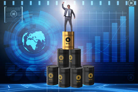 Businessman on top of oil barrelsの写真素材