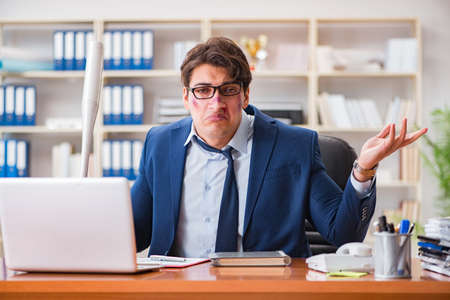 Angry aggressive businessman in the officeの写真素材