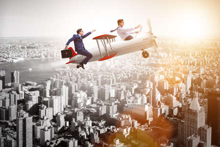 Businessman flying on vintage old airplaneの写真素材