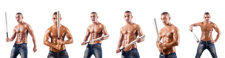 Muscular man with baseball bat on whiteの写真素材