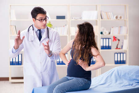 Doctor examining pregnant woman patientの写真素材