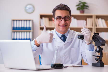 Young lab assistan working in the laboratoryの写真素材