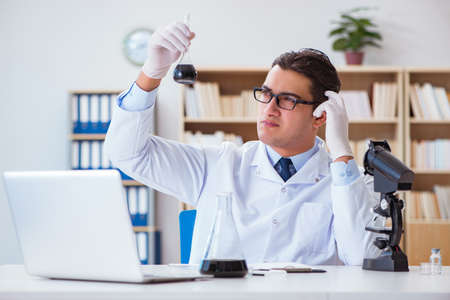 Chemical engineer working on oil samples in labの写真素材