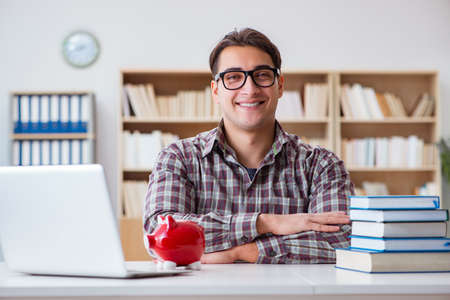 Student breaking piggybank to pay for tuition feesの写真素材