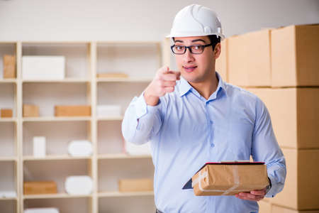 Young worker in the postal office dealing with parcelsの写真素材