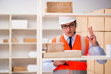 Man working in postal parcel delivery service office
