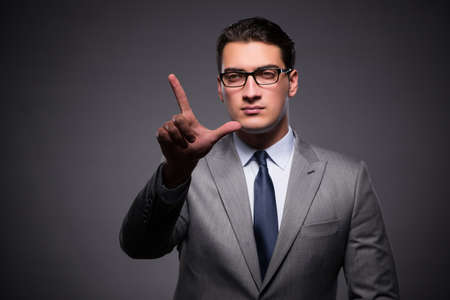 Handsome businessman pressing virtual buttonsの写真素材