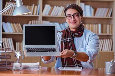 Young book writer writing in library