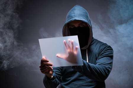 Hacker working on tablet in darkの写真素材