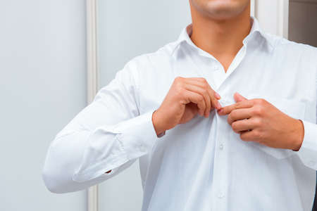 Businessman dressing up for work