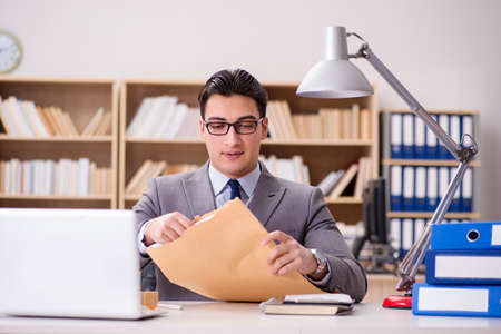 Businessman receiving letter in the officeの写真素材