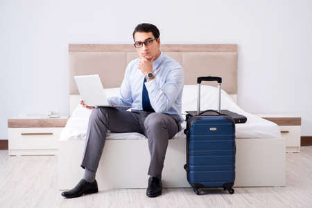 Businessman working in hotel roomの写真素材