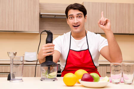 Handsome man working at the kitchen