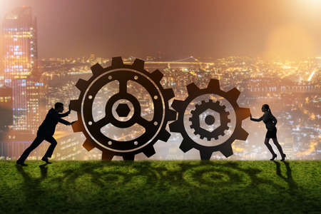 Businesspeople in teamwork example with cogwheelsの写真素材