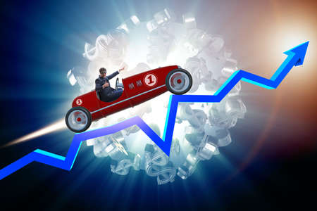 Businessman riding sports car against charts